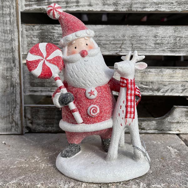 Santa holding a Candy Cane His Arm Around a Deer