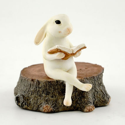 BUNNY READING ON STUMP